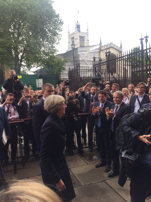 Chief Minister applauds Theresa May MP surrounded by Conservative MPs