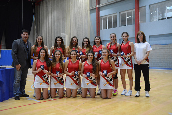 Chief Minister with the Gibraltar Netball Under 17 squad and event organiser Moira Gomez